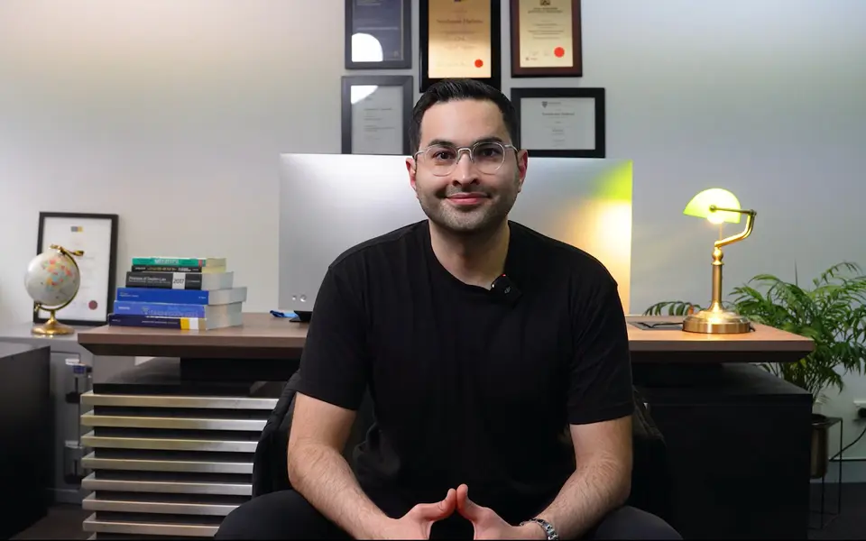 Armin Hashemi at his desk, teaching to camera